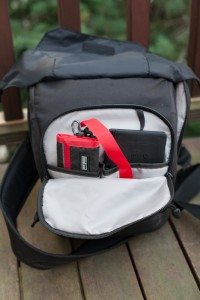 The front pocket of the bag can be accessed without unzipping the top section. Seen with ThinkTank Photo Pee Wee Pixel Pocket Rocket and X-Rite ColorChecker Passport.