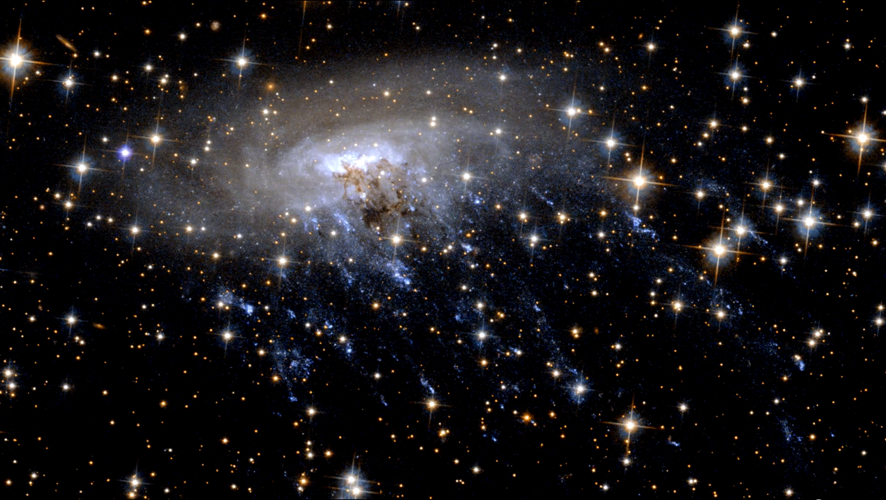Hubble Telescope Captures Extraordinary Images of a Galaxy Being Torn