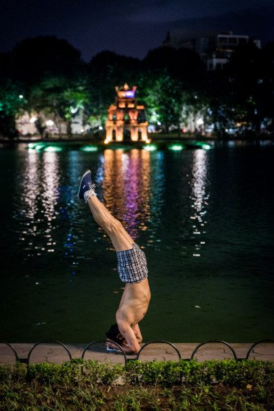 A man exercises by the side of the Hoan Kiem Lake, in Hanoi, Vie