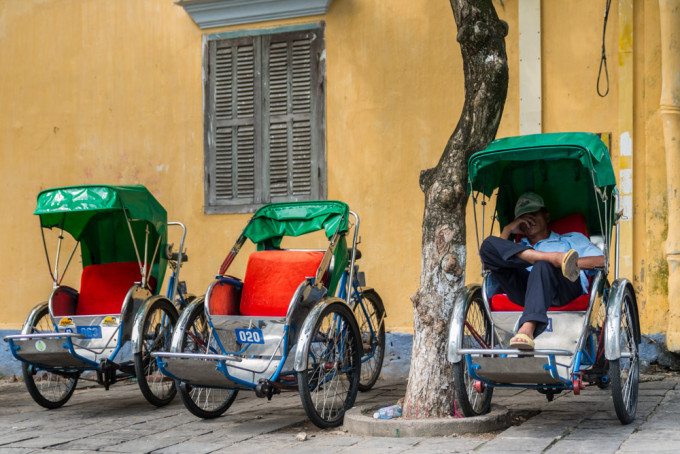 A trishaw driver takes a nap, in Hoi An, Vietnam.