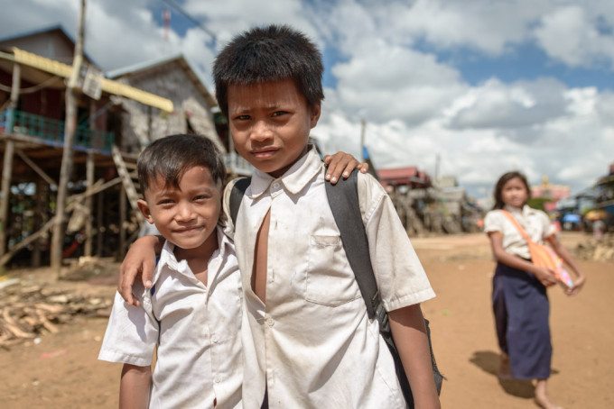 Young brothers on their way home from school, in Kompong Phluk v