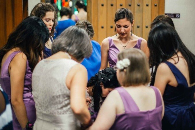 The Bridesmaids praying around the Bride. Its important to capture these moments, while remaining unobtrusive. 
