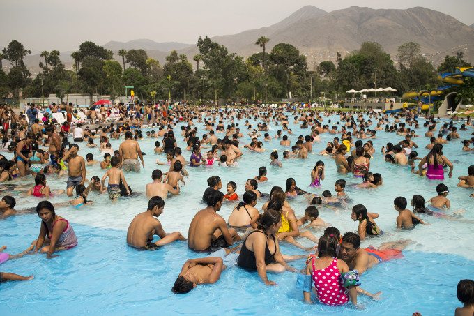 People relax at a public pool in the district of Comas in Lima, Peru on a Sunday afternoon during the summer season. This is one of Peru's largest public pools and it is know as "The Sea of Comas". Photo by Oscar Durand