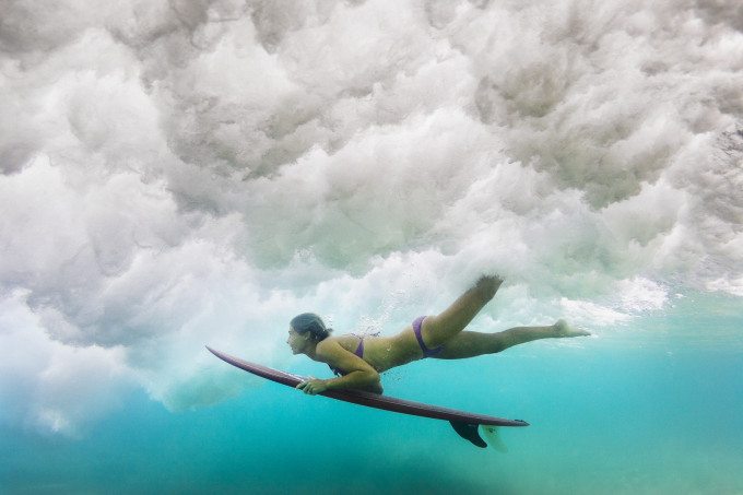 Belinda Baggs ducking underneath a wave in New South Wales, Australia