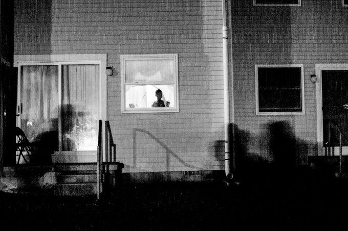 A young girl looks out of a window of her home in the Back Maryland neighborhood of Atlantic City, a section of the city struck with recent violence. Residents fear leaving their homes at night because of the violence in their neighborhood.