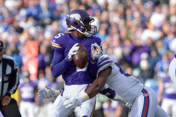Minnesota Vikings quarterback TEDDY BRIDGEWATER (5) is sacked by Buffalo Bills defensive end JERRY HUGHES (55) in the fourth quarter at Ralph Wilson Stadium in Orchard Park, NY. Buffalo handed Minnesota a 17-16 defeat with a last second touchdown.