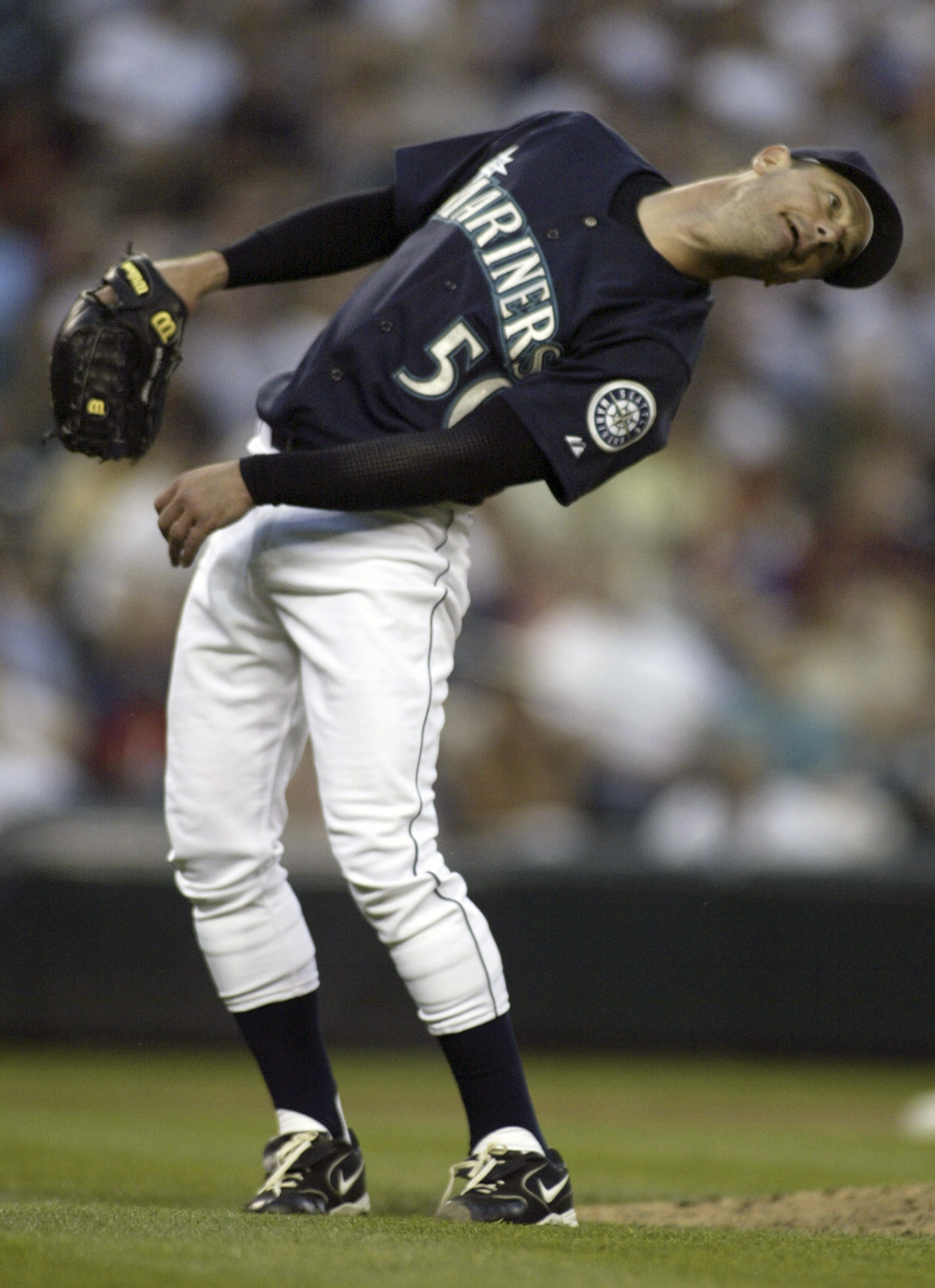 Seattle Mariners' Jamie Moyer uses a little body english to help right fielder Ichiro Suzuki catch Colorado Rockies' Ryan Spilborgh's pop fly in the ninth inning in Seattle on June 30, 2006. The Rockies beat the Mariners 2-0. ©2006. Jim Bryant Photo. All Rights Reserved.