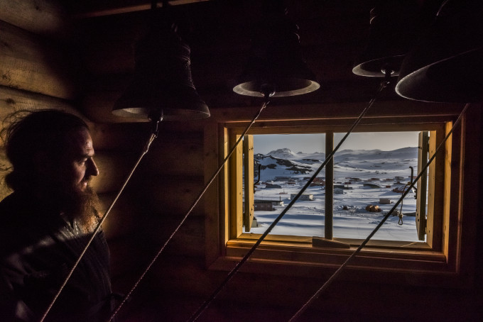 5. ANTARCTICA - DECEMBER 03, 2015: Priest, Father Benjam Maltzev looks on in the Bell room, after a vigil at the Russian Orthodox Church of the Holy Trinity on the 3rd of December, 2015 at the Bellingshausen Russian Antarctic research base in the Fildes Peninsula on King George Island, Antarctica. More than a century has passed since explorers raced to plant their flags at the bottom of the world. But today, an array of countries are rushing to assert greater influence in Antarctica. Russia built the continent’s first Orthodox church, pictured here, on a glacier-filled island with fjords and elephant seals. Less than an hour away by snowmobile, Chinese labourers have updated the Great Wall Station, a linchpin in China’s plan to operate 5 bases on Antarctica. And India’s futuristic new Bharathi base resembles a spaceship. The continent is supposed to be protected as a scientific preserve for decades to come, but many are looking toward the day those protective treaties expire — and exploring the strategic and commercial opportunities that exist right now.
