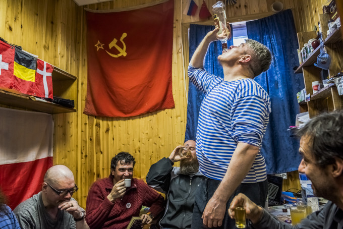 7. ANTARCTICA - NOVEMBER 28, 2015: The winter expedition crew of Russian research team and (R) Chilean scientist Dr Ernesto Molina, drink "Samagon" a home-made vodka, as they sit in a bedroom of the Bellingshausen Antarctica base on the 28th of November, 2015 near Villa Las Estrellas, in the Fildes Peninsula on King George Island, Antarctica. More than a century has passed since explorers raced to plant their flags at the bottom of the world. But today, an array of countries are rushing to assert greater influence in Antarctica. Russia built the continent’s first Orthodox church, pictured here, on a glacier-filled island with fjords and elephant seals. Less than an hour away by snowmobile, Chinese labourers have updated the Great Wall Station, a linchpin in China’s plan to operate 5 bases on Antarctica. And India’s futuristic new Bharathi base resembles a spaceship. The continent is supposed to be protected as a scientific preserve for decades to come, but many are looking toward the day those protective treaties expire — and exploring the strategic and commercial opportunities that exist right now.