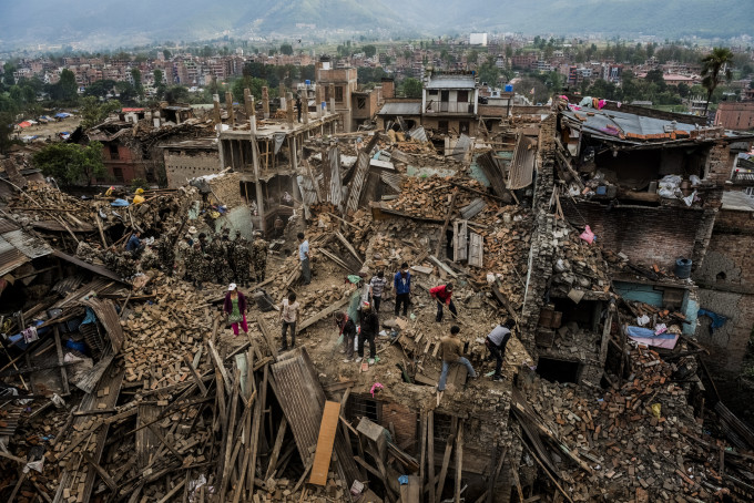 5—Bhaktapur, Nepal. Wednesday, April 29, 2015: Residents forage through their destroyed homes, gathering salvageable belongings on April 29, 2015 in Bhaktapur, Nepal. On the 25th of April, just before noon local time, as farmers were out in fields and people at home or work, a devastating earthquake struck Nepal, killing over 8,000 people and injuring more than 21,000 according to the United Nations Office for the Coordination of Humanitarian Affairs. Homes, buildings and temples in Kathmandu were destroyed in the 7.8 magnitude quake, which left over 2.8 million people homeless, but it was the mountainous districts away from the capital that were the hardest hit. Villagers pulled the bodies of their loved ones from the rubble by hand and the wails of grieving families echoed through the mountains, as mothers were left to bury their own children. Over the following weeks and months, villagers picked through ruins desperate to recover whatever personal possessions they could find and salvage any building materials that could be reused. Despite relief teams arriving from all over the world in the days after the quake hit, thousands of residents living in remote hillside villages were left to fend for themselves, as rescuers struggled to reach all those affected. Multiple aftershocks, widespread damage and fear kept tourists away from the country known for its searing Himalayan peaks, damaging a vital climbing and trekking industry and compounding the recovery effort in the face of a disaster from which the people of Nepal continue to battle to recover.