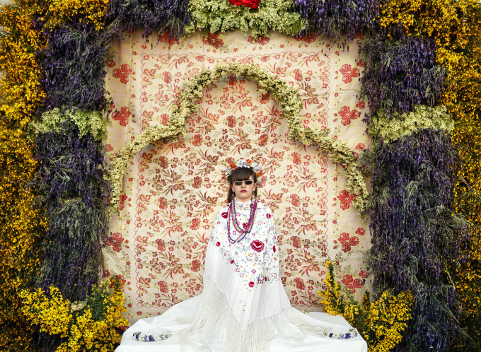 A 'Maya' girl sits in an altar during the traditional celebration of 'Las Mayas' on the streets in Colmenar Viejo, near Madrid, Spain, Friday, May 2, 2014. The festivity of 'Las Mayas' comes from pagan rites and dates from at least the medieval age, appearing in ancient documents. It takes place every year in the beginning of May and celebrates the arrival of the spring. A girl between 7 and 11years is chosen as 'Maya' and should sit still, serious, and quiet for a couple of hours in an altar on the street decorated with flowers and plants, afterwards they walk to the church with their family where they attend a ceremony. Not more than four, or five girls are chosen as a Maya each year.
