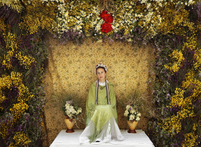 A 'Maya' girl sits on an altar during the traditional celebration of 'Las Mayas' on a street in Madrid, Spain, on Sunday, May 11, 2014. The festivity of 'Las Mayas' comes from pagan rites and dates from at least the medieval age, appearing in ancient documents. It takes place every year in the beginning of May and celebrates the arrival of the spring. A girl between 7 and 11years is chosen as 'Maya' and should sit still, serious, and quiet for a couple of hours in an altar on the street decorated with flowers and plants, afterwards they walk to the church with their family where they attend a ceremony. Not more than four, or five girls are chosen as a Maya each year.
