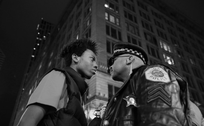 Lamon Reccord, left, scolds a police sergeant during a police violence protest and march at State and Randolph streets Wednesday, Nov. 25, 2015, in Chicago. (John J. Kim/Chicago Tribune)