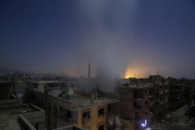 Smoke billows from a building early on October 30, 2015, following reported shelling by Syrian government forces in the rebel-controlled area of Douma, east of Damascus. AFP PHOTO / SAMEER AL-DOUMY