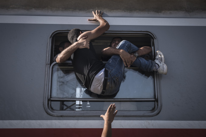3 – Migrants struggled to climb onto a train headed to Zagreb, the Croatian capital.