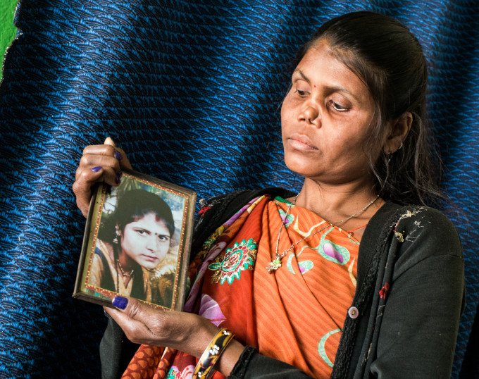 Radha, age 30, with a portrait of herself before leprosy caused her nasal cartilage to collapse