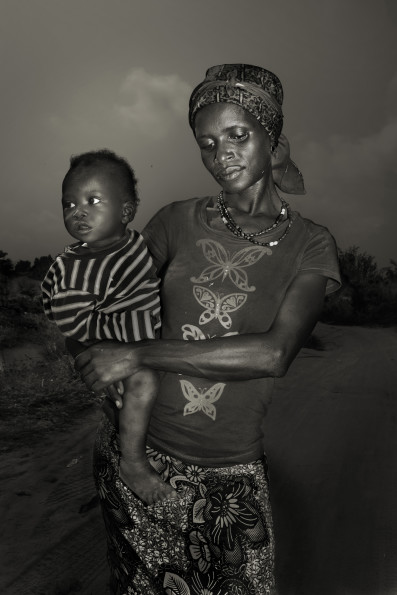 Fatmata Kamara, 25, with her son Koday, 1. She has lost her husband and her aunt. She contracted ebola together with her son. They both survived the infection thanks to the cures given by Emergency. They live in Waterloo, a village developed from a refugee camp, heavely stroke by ebola in December 2014.