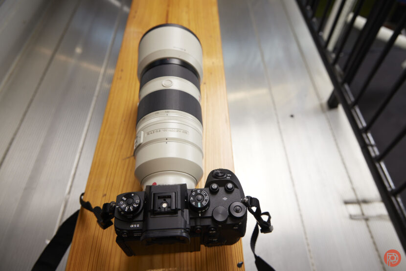 I’m a Sony Camera Fan The Sony a9 III sits on top of a wooden bench.