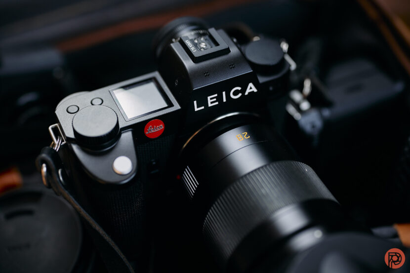 Is Leica Working on its Most Exciting SL Camera Yet? Close-up of a black Leica camera with a lens attached, showing the brand name and controls.
