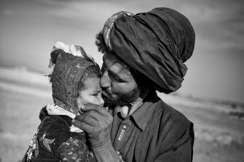 Anja Niedringhaus for the Phoblographer An Afghan nomad kisses his young daughter while watching his herd in Marjah, Helmand province, October 20, 2012