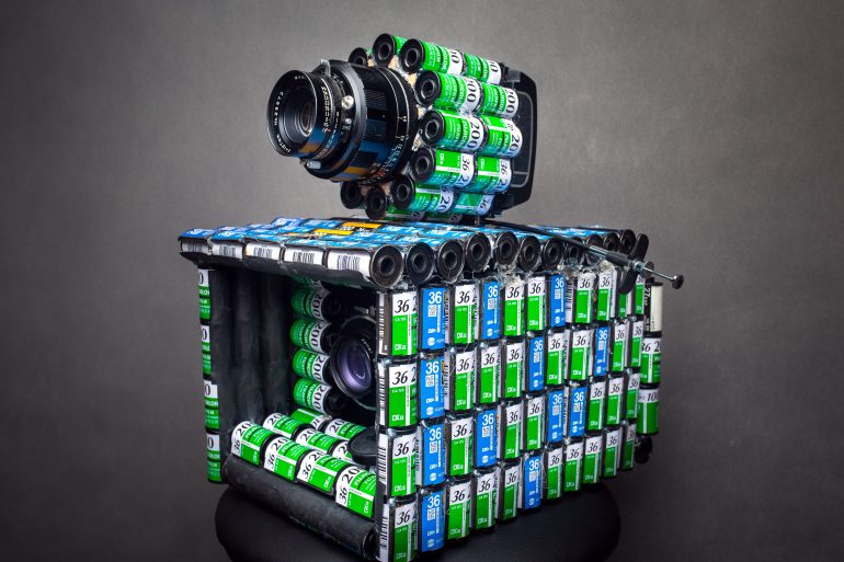 Crafted as a DIY camera, this unique creation combines numerous 35mm film canisters with a lens and shutter mechanism, offering a blend of creativity and functionality.
