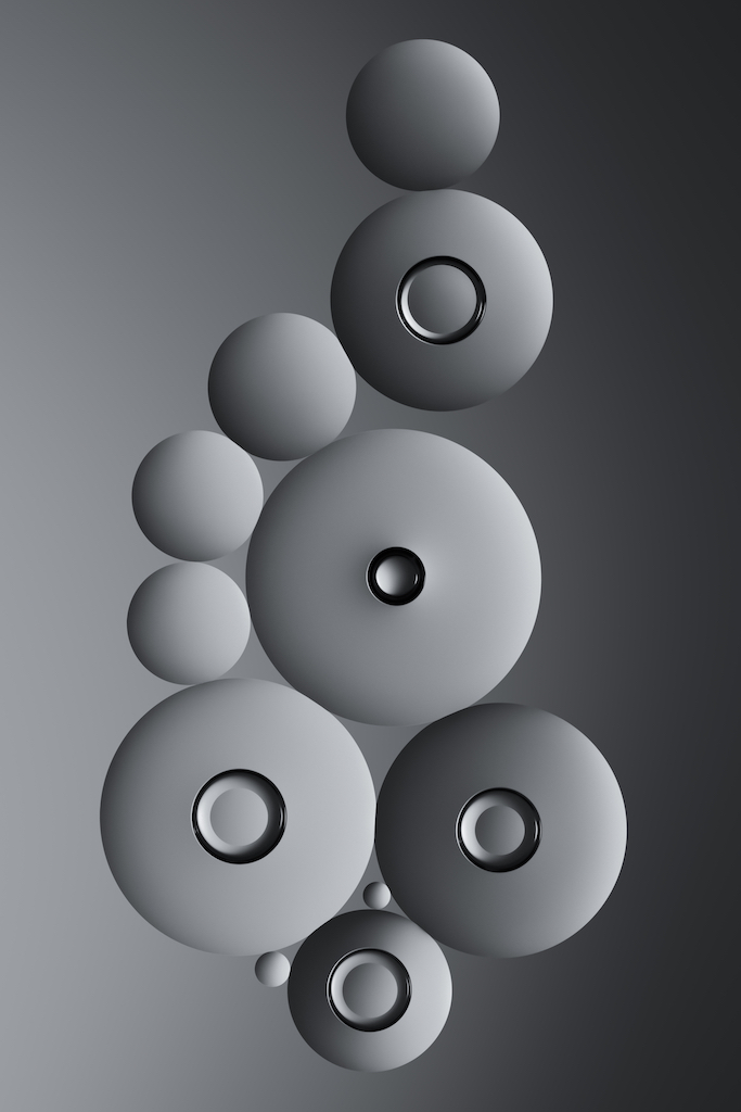 A grayscale image features concentric circles in varying sizes, layered against a gradient background. The circles boast a 3D metallic texture with glossy highlights, creating an illusion of depth and artistic mastery. Image by Matt Vacca.