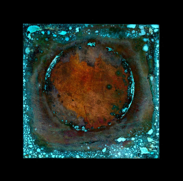A textured, square artwork reminiscent of a Close-up Photographer of the Years capture, features a rusty red and brown circular area surrounded by oxidized turquoise blue patterns. The design has an aged, corroded appearance with varying shades and speckles, set against a black background.