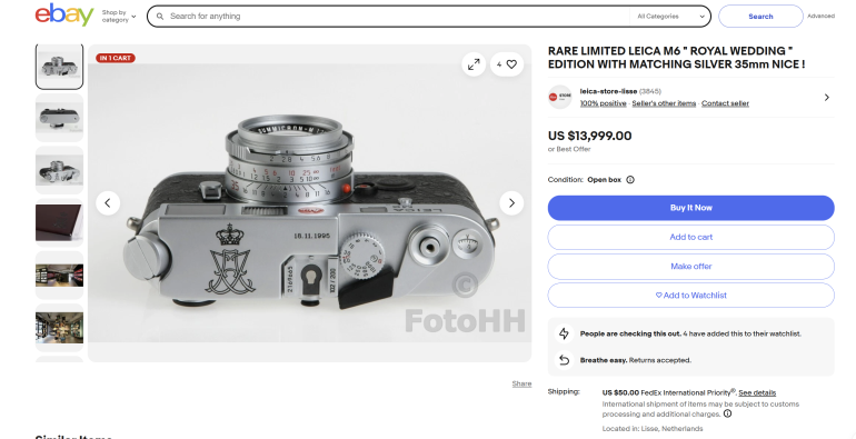 Top view of a silver Leica M6 camera with engraved crest, displayed on an eBay listing for $13,999.