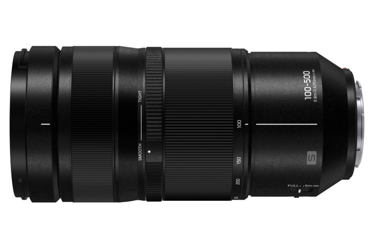 Black interchangeable camera lens with zoom and focus rings, labeled 100-500mm with lens mount visible on one end.