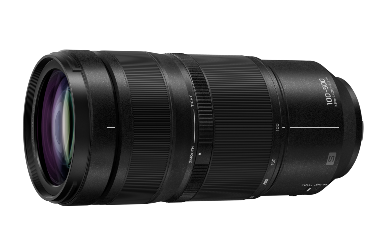 Black camera lens with zoom and focus rings, labeled 100-500mm and S on the side, against a white background.