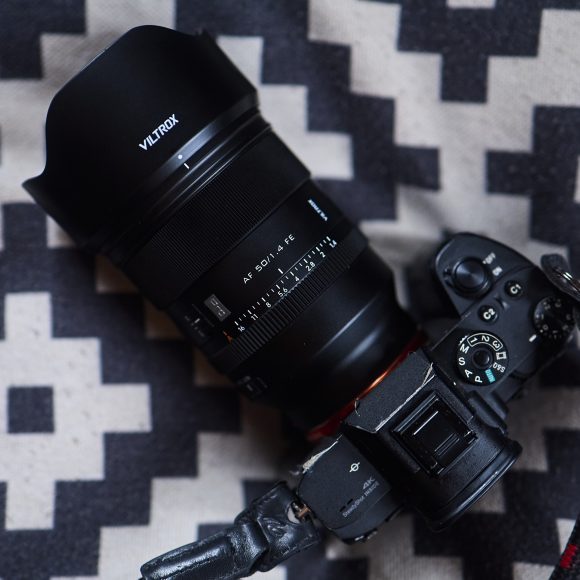 A Viltrox camera with a wide lens rests on a black and white geometric patterned surface.