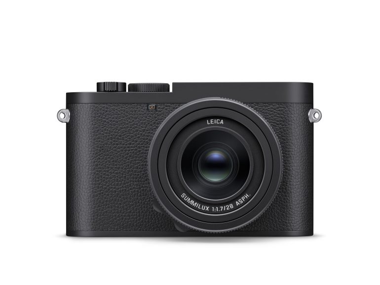 Front view of a black Leica digital camera with a large lens and textured grip.