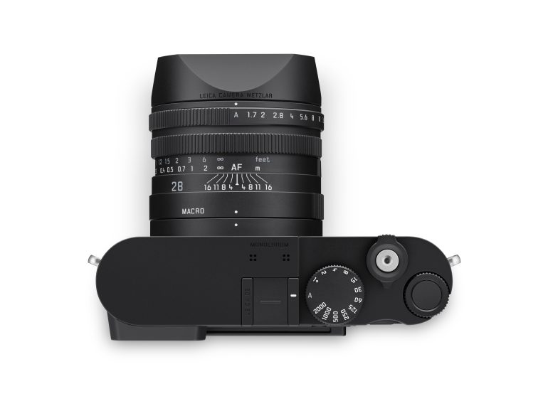 Top view of a black Leica camera with a 28mm lens, showing dials and focus settings.