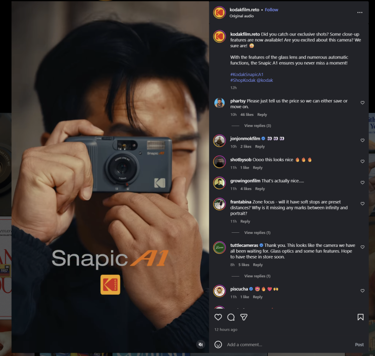 A person holds a Kodak Snapic A1 camera up to their face, preparing to take a photo.