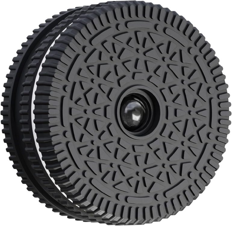 Black, round object resembling an Oreo cookie with a geometric pattern and a camera lens in the center.