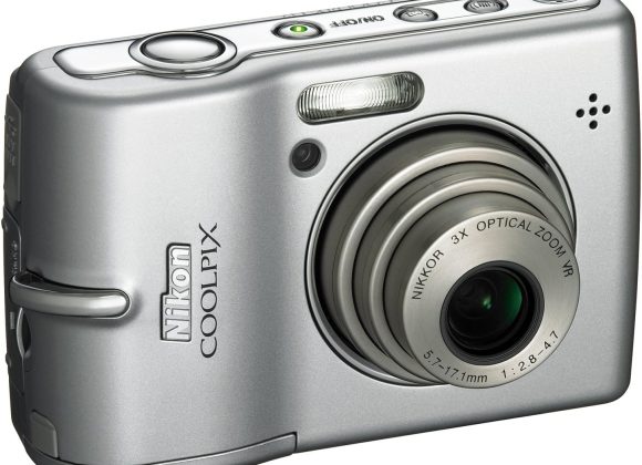 A silver Nikon Coolpix digital camera with a 3x optical zoom lens, shown from a front angle.