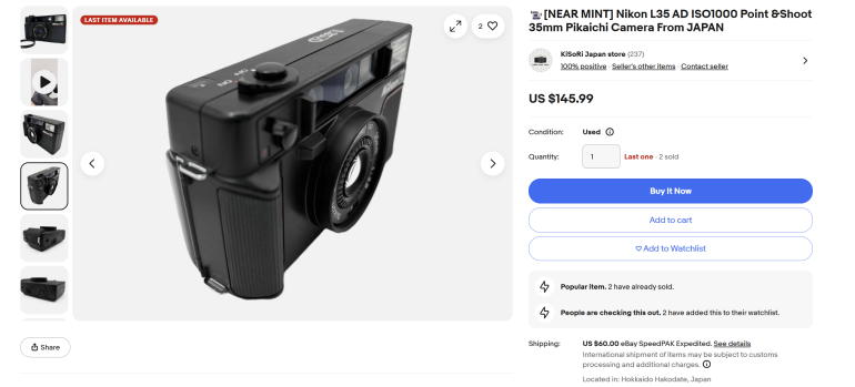 Black Nikon L35 AD 35mm point-and-shoot film camera angled left, displayed for sale on eBay.
