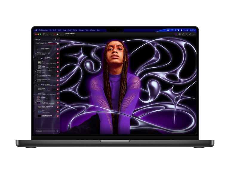 A laptop displays digital art editing software with a vibrant portrait of a person on the screen.