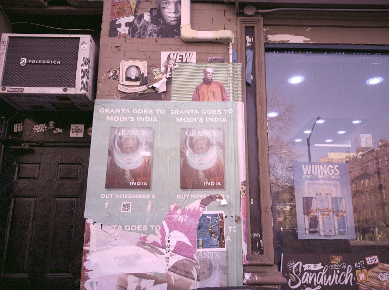 Posters and flyers on a wall next to a shop window displaying Wiings energy drinks.