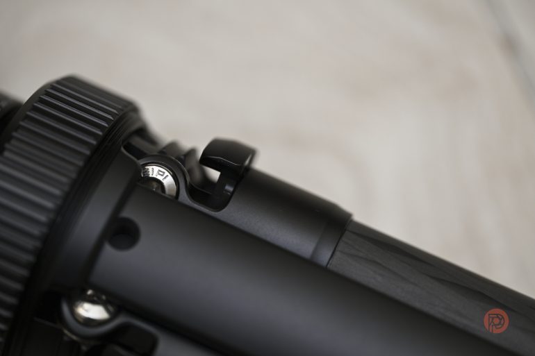 Close-up of a black mechanical part with a textured dial and engraved number 13.