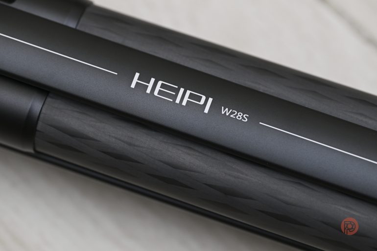 Close-up of a black item labeled HEIPI W28S with a textured pattern and white logo.