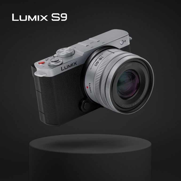 A silver and black Lumix S9 camera floating above a black pedestal on a dark background.