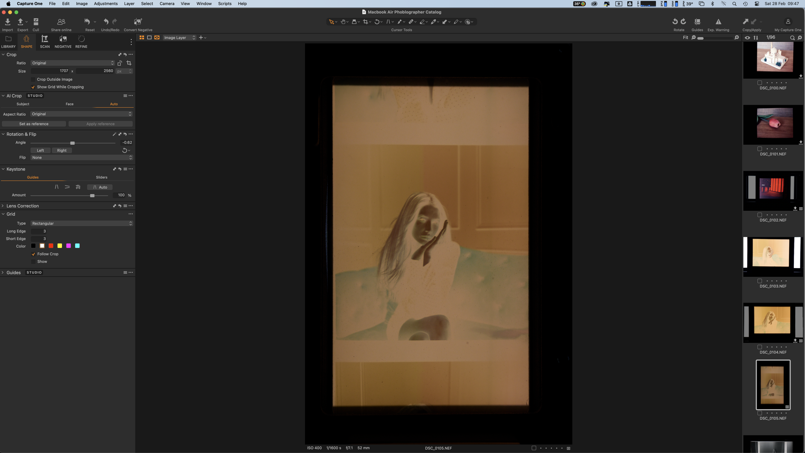 A film negative of a woman on a sofa is displayed in a photo editing software interface.