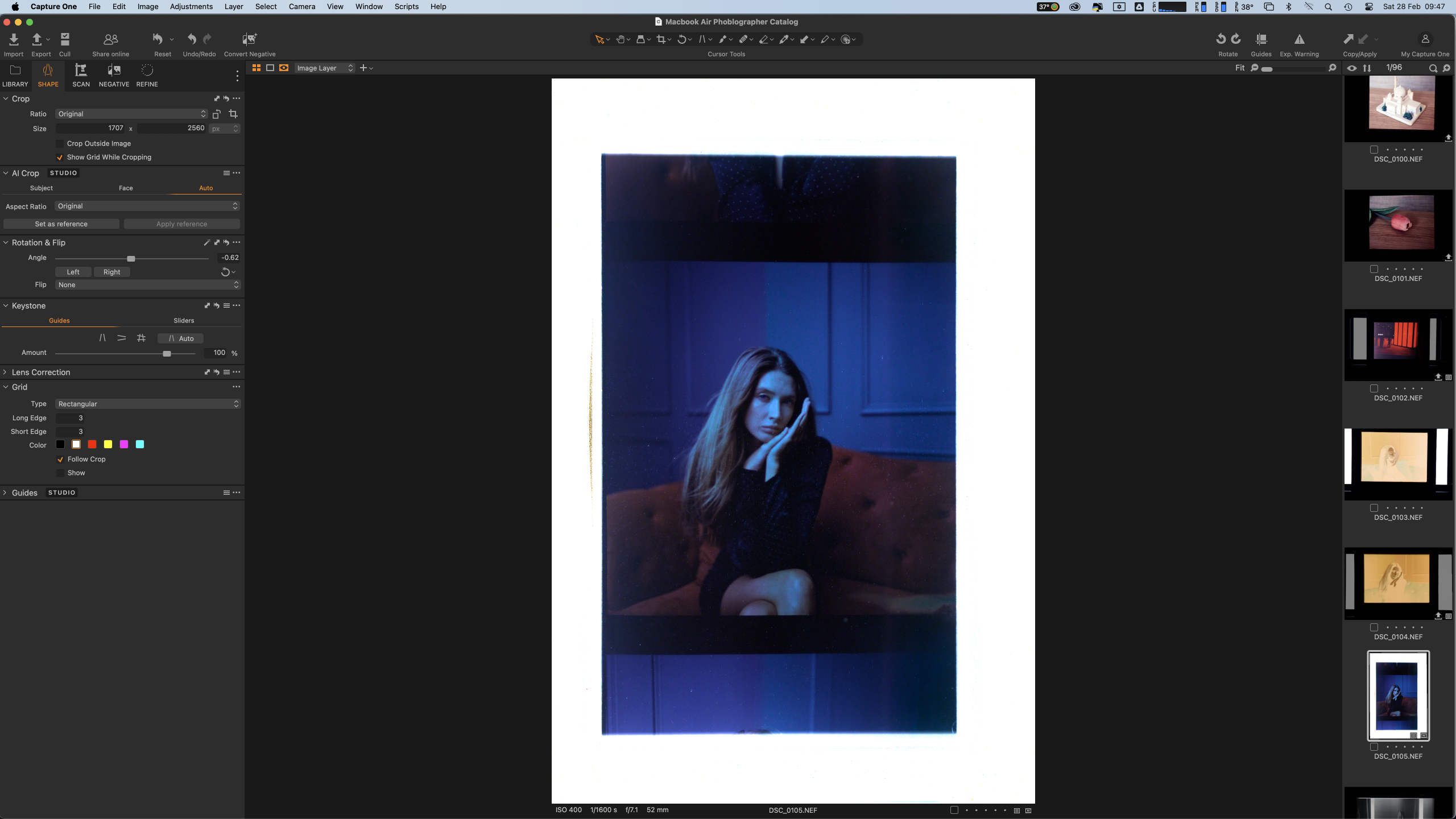 Screenshot of photo editing software with a portrait of a woman sitting on a sofa in blue-toned lighting.