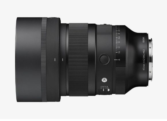 A black Sigma 85mm camera lens shown in a side profile view on a white background.