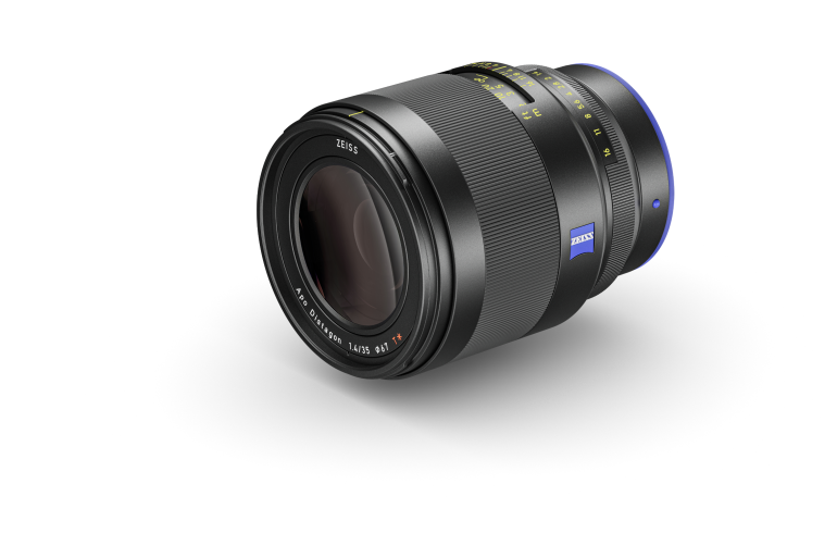 A black Zeiss camera lens with blue accents, shown on a white background.