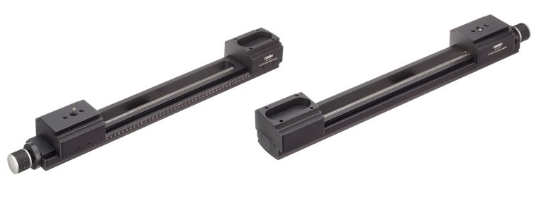 Two black linear motion stages with adjustment knobs and mounting holes, shown on a white background.