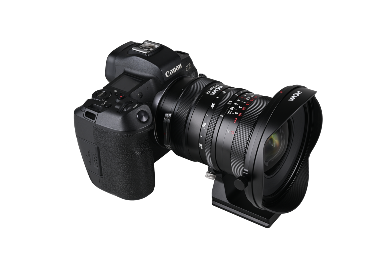 Black Canon digital camera with a large Voigtländer lens attached, shown on a white background.