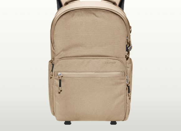 Beige backpack with multiple zippered compartments and padded shoulder straps, displayed on a light background.