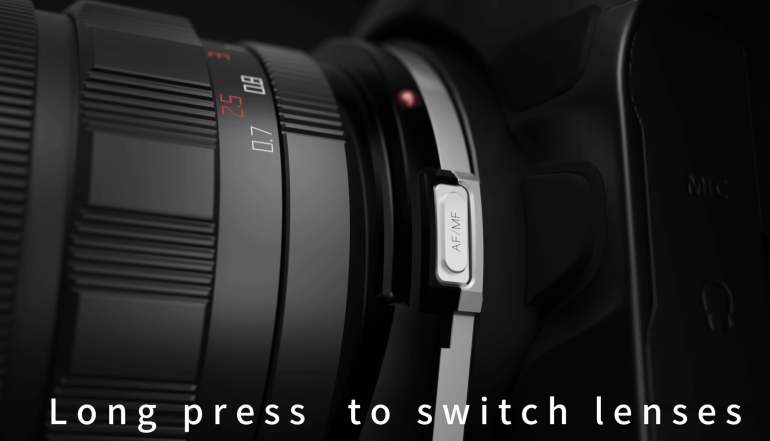 Close-up of a camera lens with a switch labeled AF/MF and text: Long press to switch lenses.